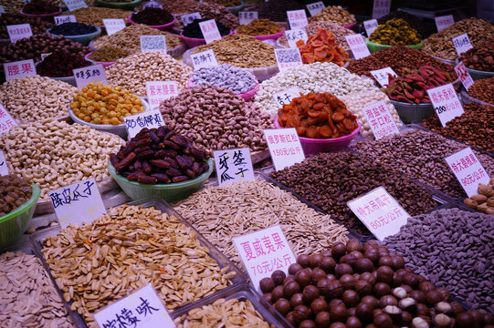 Assorted Nuts and Dried Fruits for Sale at a Busy Market Stall