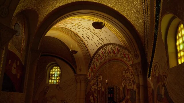 Amber light reveals painted vaults and intricate sacred ornament