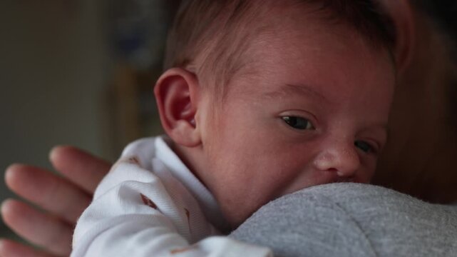 Mother Burping Restless Newborn Baby After Feeding