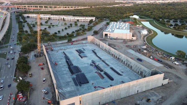 Concrete loading aprons border perimeter fence line Metroplex presents expansive concrete foundations, rising steel frames, ongoing construction activity along DFW, Lewisville, Texas