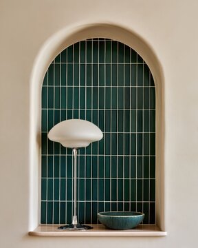 Modern interior arched alcove with green tiles, chrome floor lamp and ceramic bowl for interior design, poster, background