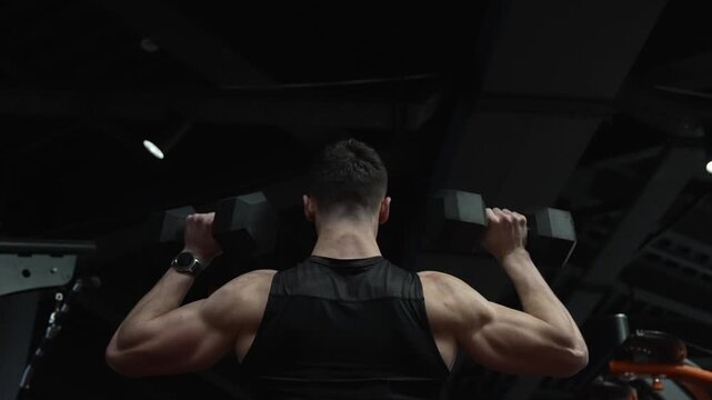 Strong triceps. Man exercising with dumbbell. Man athlete lifting dumbbell. Strong man do sport exercise. Gym workout. Sport athlete man with dumbbell. Compact dumbbell. Biceps muscle