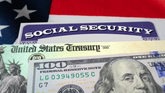 Closeup of social security benefits card, US treasury check, 100 dollar bill with American flag in the background. Social security benefits payment, retirement, federal government benefits. 4k footage