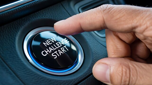 Finger pressing engine start button inside a modern car