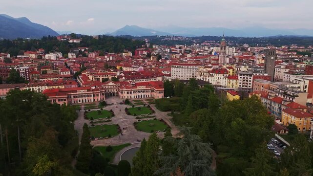 Aerial drone view of Comune di Varese, Palazzo Estense and Giardini Estensi in Varese, Italy, showcasing the historic palace, formal gardens, greenery, and cityscape.