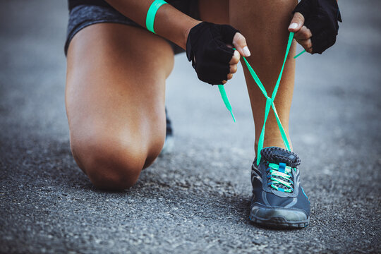Woman Tying Running Shoes Before an Outdoor Workout