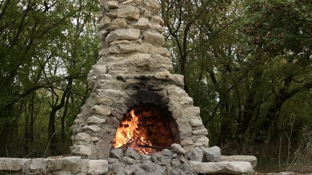 Fire burning in old outdoor stone oven with crackling sound