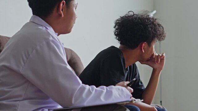 Young man suffering from Post Traumatic Stress Disorder who was indifferent toward doctor