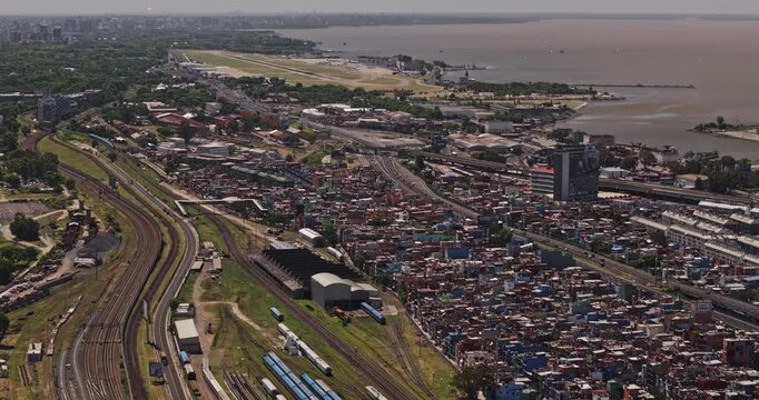 Buenos Aires Argentina Aerial v48 zoomed flyover above Barrio Padre Mugica and Retiro railways toward Recoleta, Aeroparque and Rio de la Plata - Shot with 5k Camera - Jan 3rd 2026