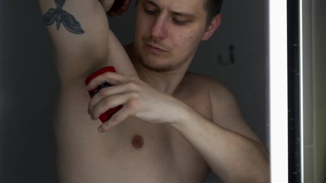 Use of underarm deodorant by a young man.
Protection against sweating.