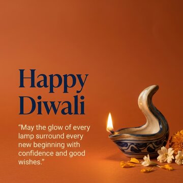 Happy Diwali festival wishes with single ceramic oil lamp and orange marigold flowers on simple rustic orange surface.