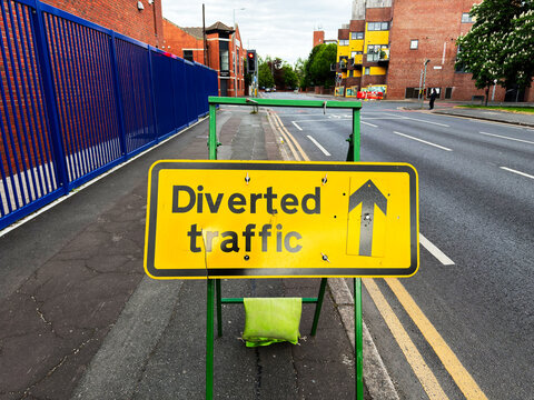 Diverted traffic sign on a quiet urban street in Manchester UK indicating temporary route direction during daytime roadworks