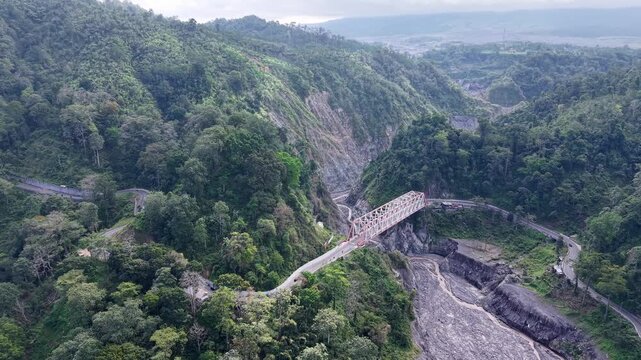 Aerial drone view of lahar scarred gorge and bridge near Mount Semeru in Lumajang.