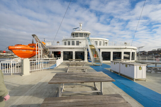 Moss, Norway - April 03 2026: Ferry deck with seating area lifeboat and upper bridge structure under daylight sky.