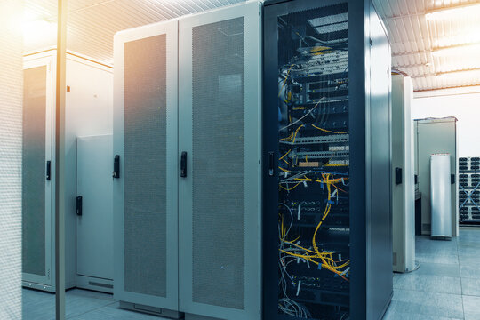Data center infrastructure with server racks and network cabinets inside telecommunications facility supporting cloud computing, enterprise IT systems and digital connectivity.