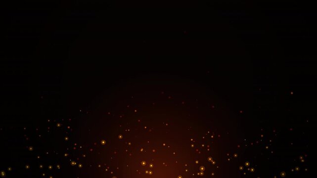 Golden glowing particles floating against a black background