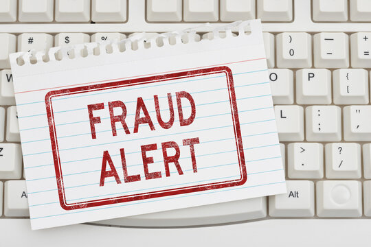 Fraud Alert warning sign on a keyboard