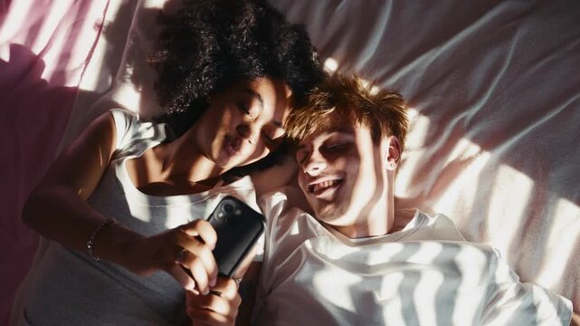 Couple sharing romantic moment, lying in bed.