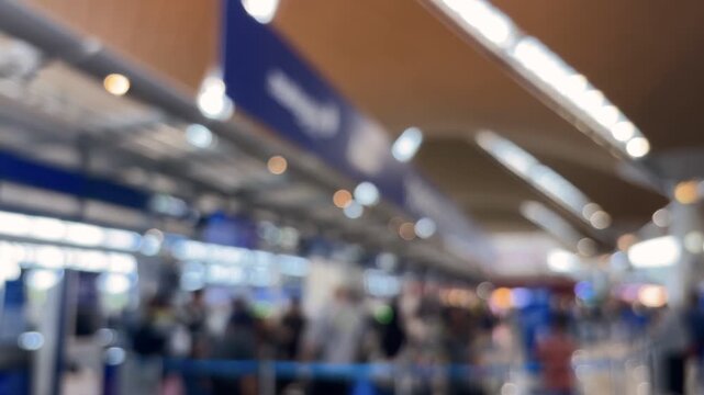 Passengers queue to board a plane at the airport terminal. Blur video.