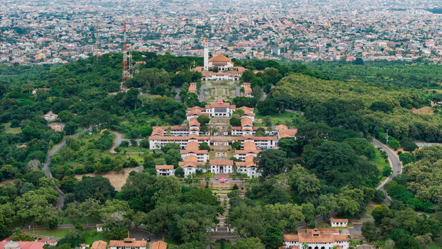 Aerial view of University of Ghana campus building on a hill with a sprawling Accra city in the background