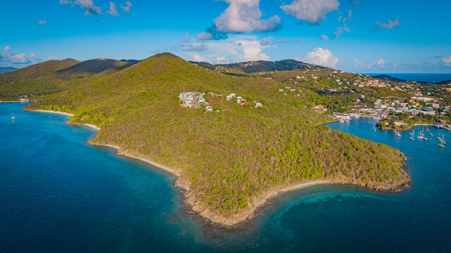 Stunning aerial landscape of lush green hills surrounding Cruz Bay in US Virgin Islands.