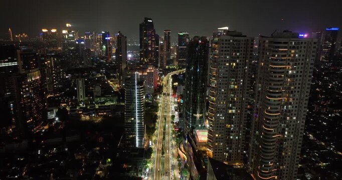 Night downtown Jakarta with high-rise buildings view from above.