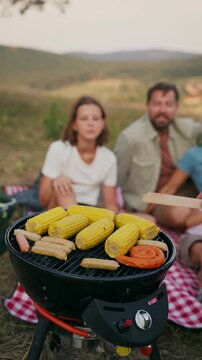Family relaxing and spending time together at campsite.