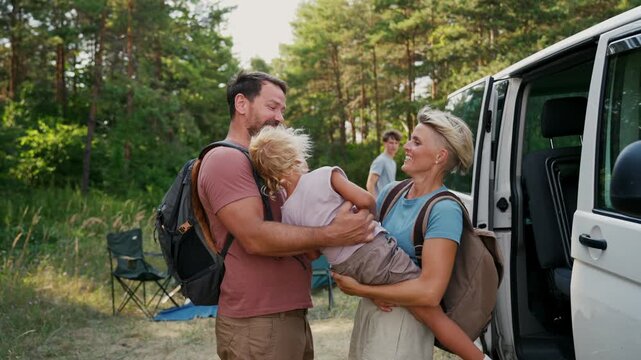 Family relaxing and spending time together at campsite.