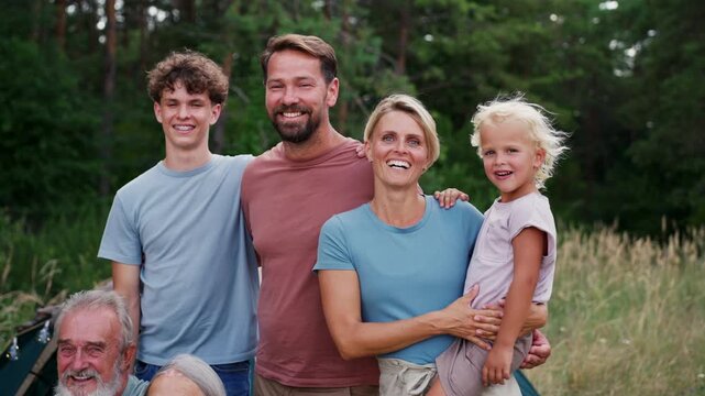 Family relaxing and spending time together at campsite.