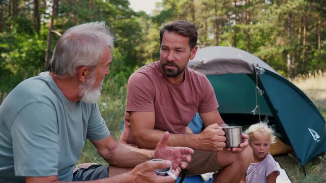Family relaxing and spending time together at campsite.