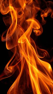 Intense flames dance in fiery display on black backdrop, featuring bright orange fire with smoke wisps and burning embers for dramatic wallpaper design