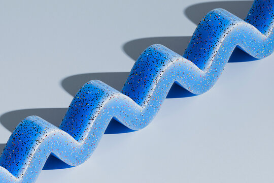 Blue Speckled Zigzag Sculpture on Minimal Background