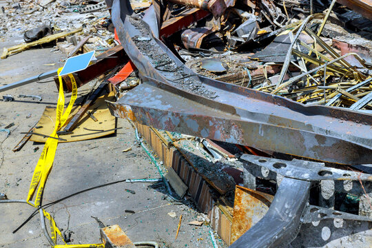 Prepare to clear debris, metal structures left after building was taken down in an urban area.