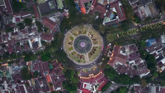Aerial view of central plaza at dusk, surrounded by red roofed buildings at Alun Alun Malang
