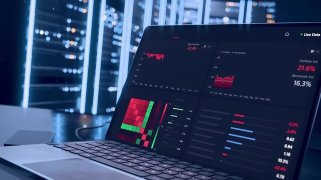 Opening laptop lid, laptop showing analytics at desk monitoring racks with LED strips, cable, phone