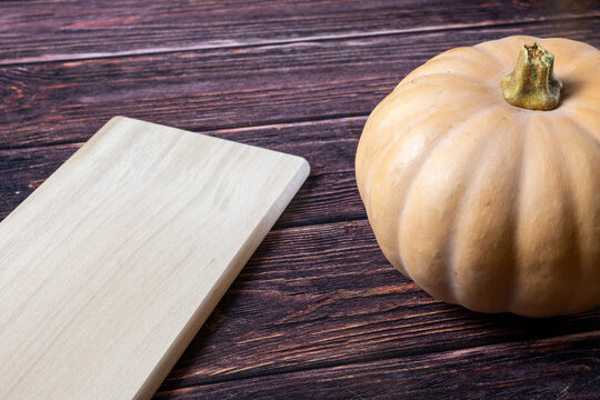Autumn Pumpkin on Rustic Wooden Table