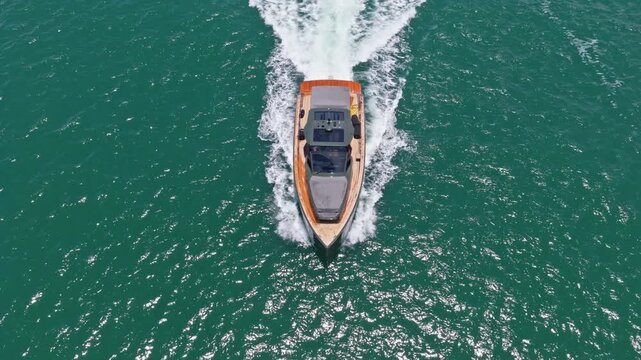 Motorboat yacht sailing at sea. Sparkling sea. Motorboat aerial top view. Luxury boat motor yacht at sea. Yachting boat tourism. Luxury lifestyle. Vacation on summer. Yacht at sea