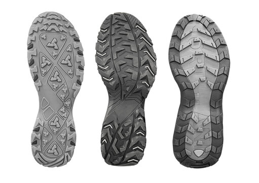 Three hiking shoe soles with distinct rubber tread patterns on transparent background