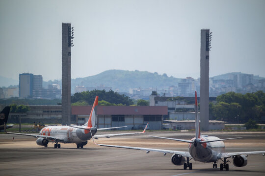 Rio de Janeiro, Brazil - 18 October 2026: View of RIOgaleao International Airport with two commercial airplanes taxiing on the tarmac.
