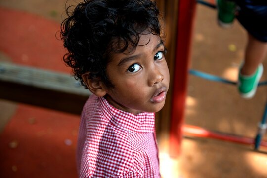 Curious child on playground equipment.