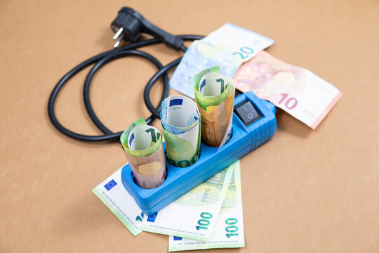 Electricity power socket with Euro banknotes, high expensive energy price, economy crisis, money for paying bill, increase costs of living, inflation and social issues