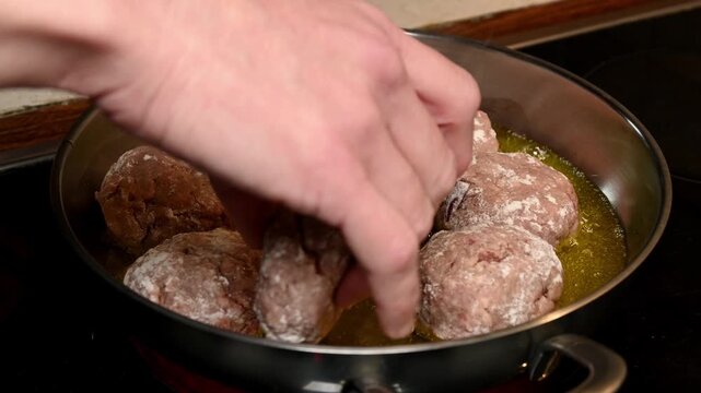 frying raw homemade minced meatballs in hot oil