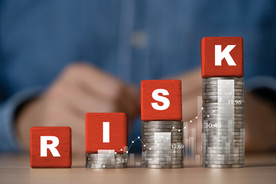 Financial risk management from investment growth concept with red RISK blocks on rising coin stacks for upward financial charts and market data and investment planning.