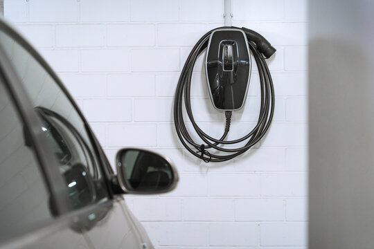 Charging station for electric cars, home charging station for electric vehicles in the garage. Wall-mounted charger or charge point for electric vehicles