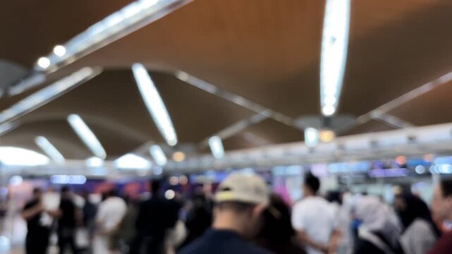 Passengers queue to board a plane at the airport terminal. Blur video.