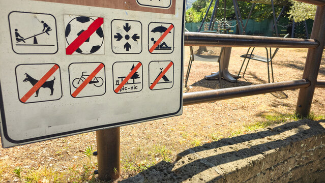 Public rules sign uses pictograms to show prohibited activities in an outdoor recreation area. Concepts: public safety, regulations, visitor guidance, responsible tourism, behavior, recreation