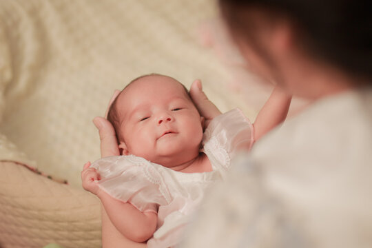 Maternal love, bonding, intimacy and family tenderness. Close up of a mother gazing affectionately at her newborn baby, highlighting their face to face connection in soft natural light.