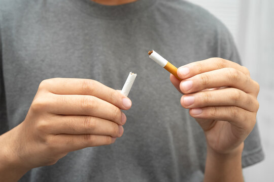 Man holding cigarette, no smoking.