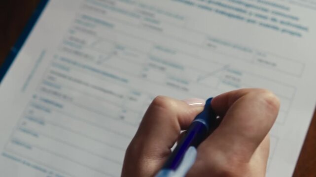 A person fills out a questionnaire by answering the questions, writing the answers by hand. High quality 4k footage