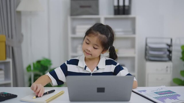 Young girl using digital tablet for studying or entertainment inside modern home environment with focus and smile